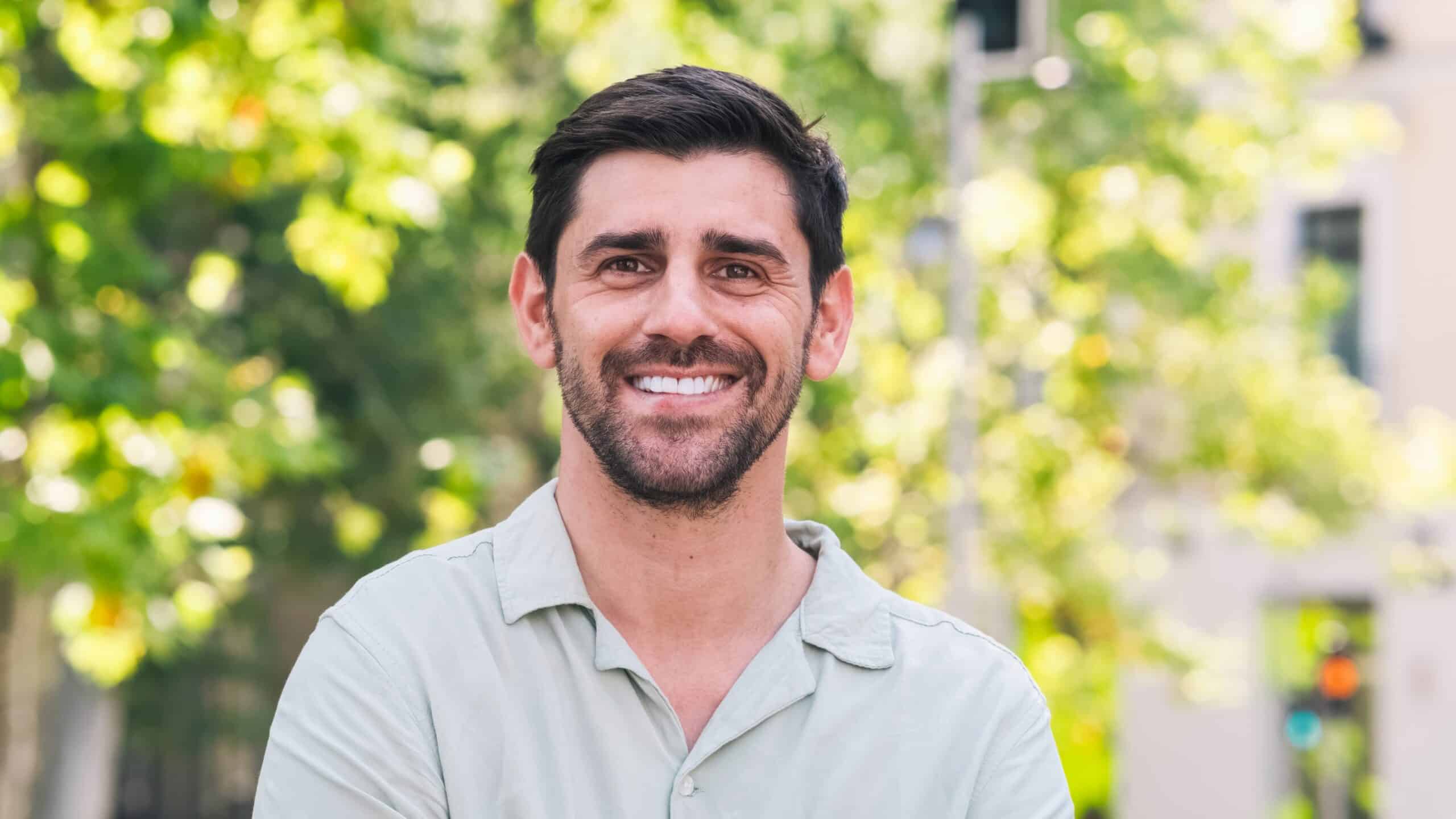 Happy,Man,Looking,At,Camera,In,City,Park,During,Daytime
