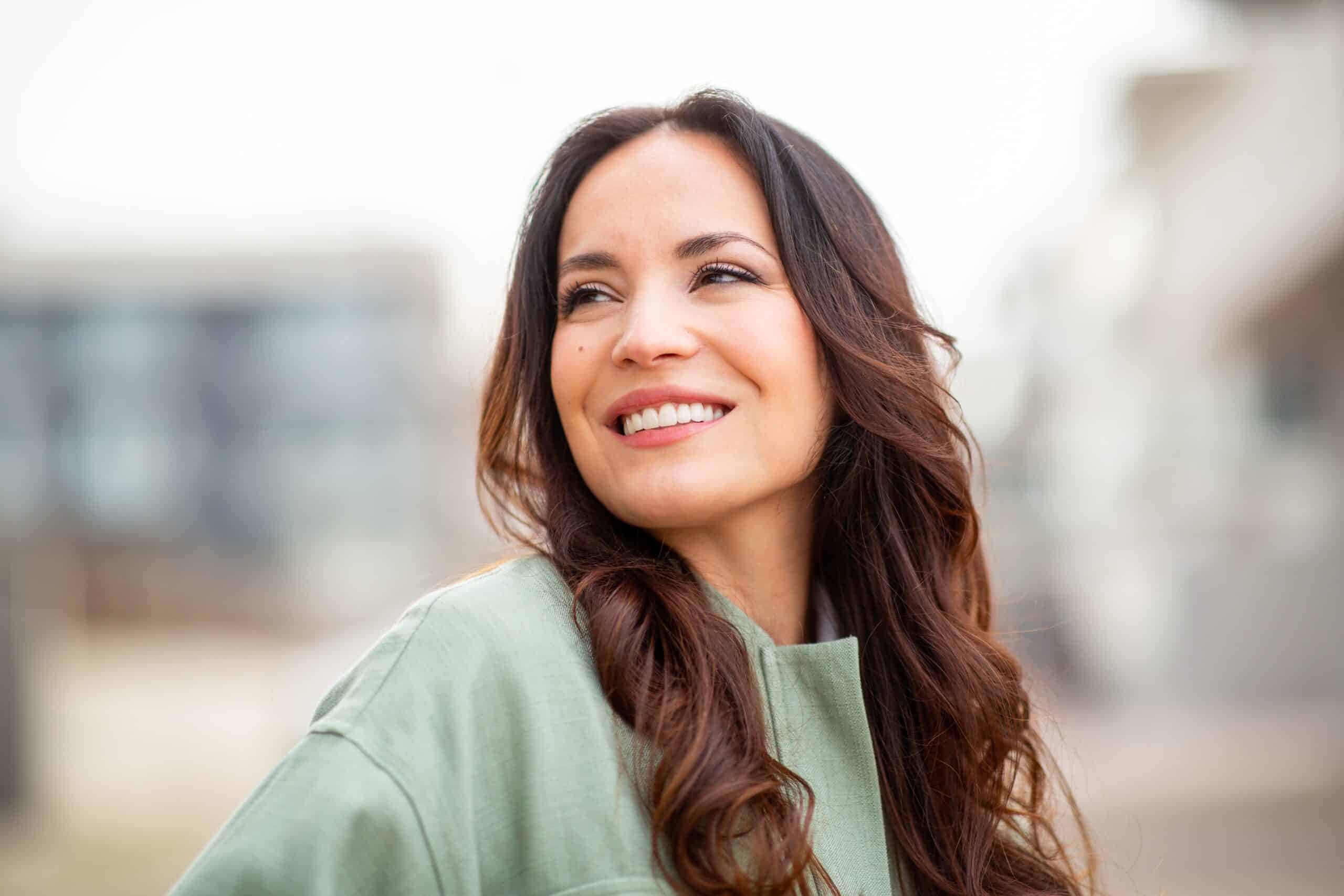 Beautiful,Young,Woman,Smiling,And,Looking,Away,With,A,Happy