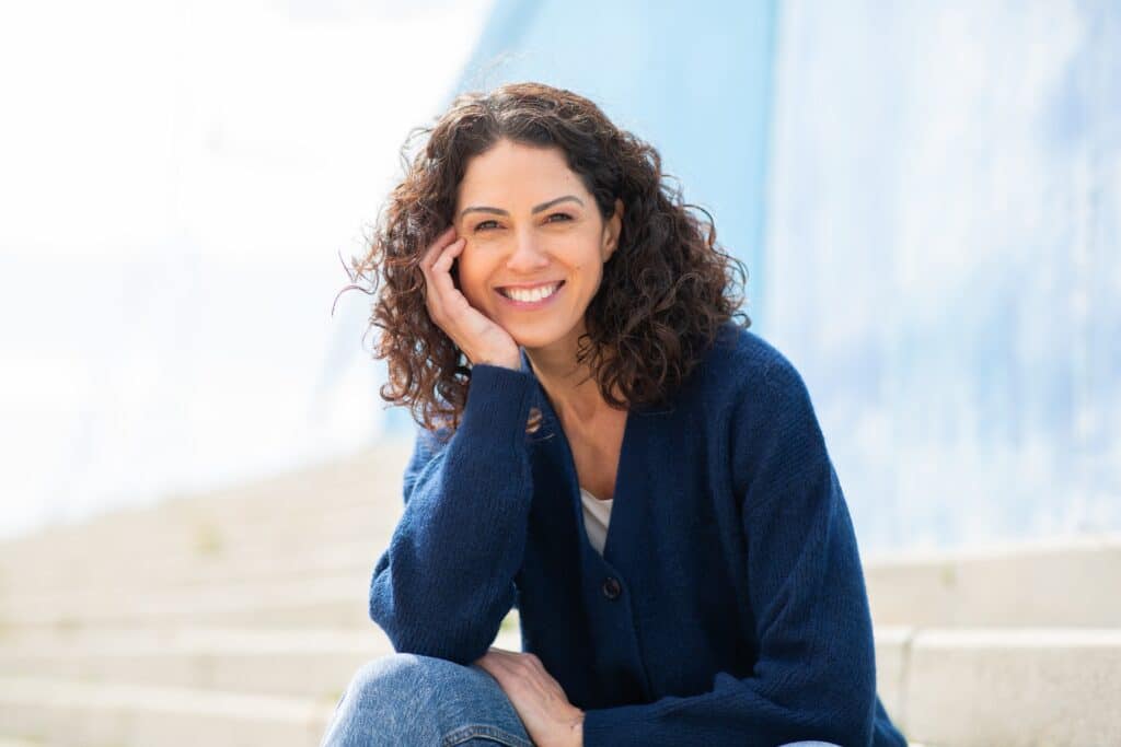 Portrait,Of,Cheerful,Woman,Sitting,On,Outdoor,Steps,And,Smiling