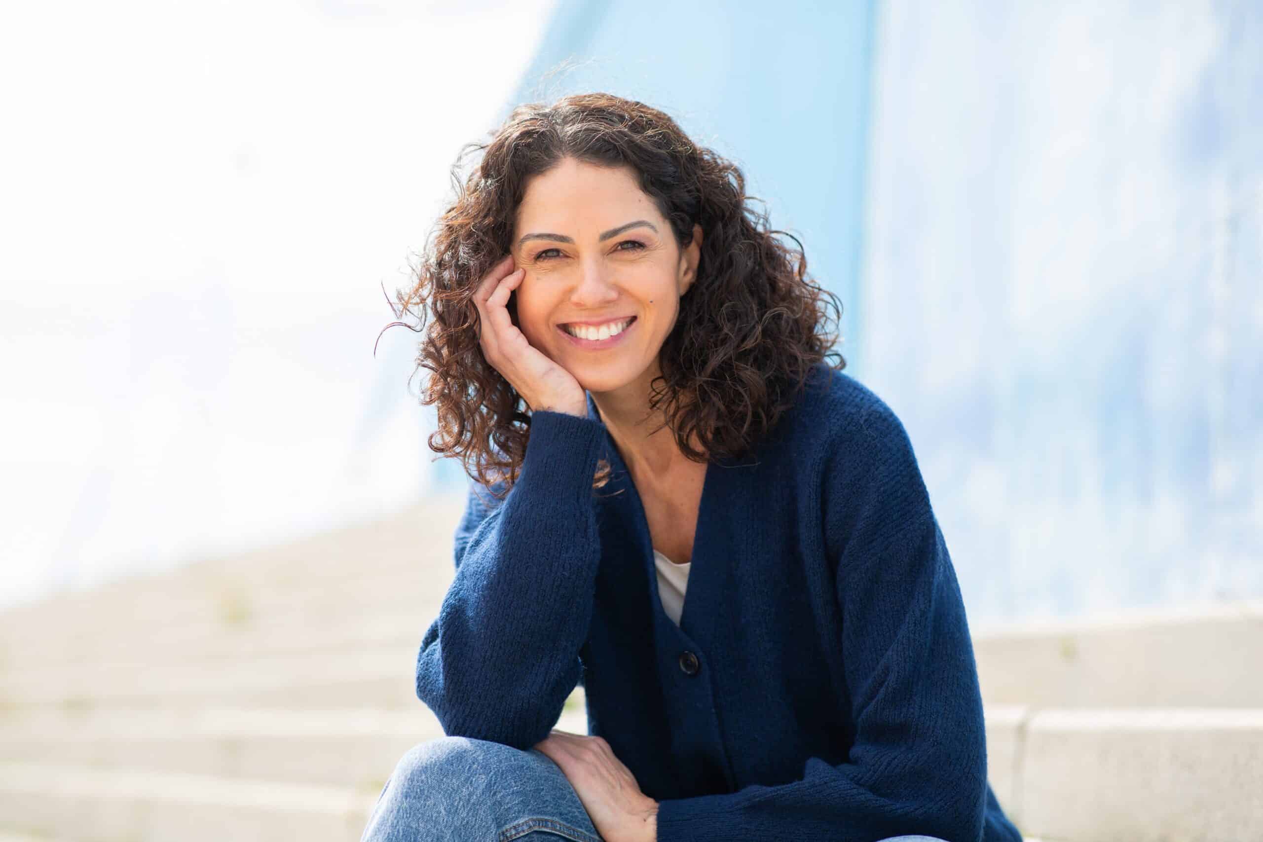 Portrait,Of,Cheerful,Woman,Sitting,On,Outdoor,Steps,And,Smiling